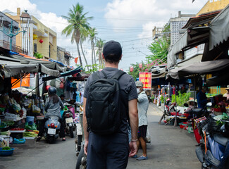 Unrecognizable Backpacker In The Middle Of A Street Market In Vietnam