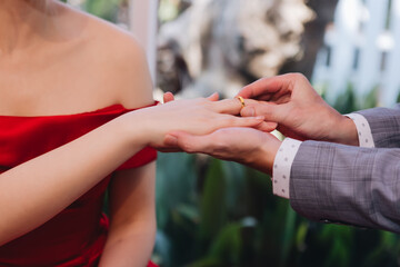 During a wedding, the bride and groom exchange wedding rings. Hand close-up