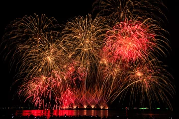 Fotobehang Chocoladebruin Real Fireworks at Pattaya bay, Pattaya national Fireworks Festival contest, November of every Year, Beautiful of bright light fireworks Show in middle sea, for postcard wallpaper background,  © SHUTTER DIN