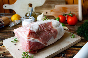 RAW pork loin on cutting board with herbs and spices. on wooden background.