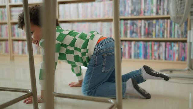 Kindergarten boy playing in the classroom. Happy schoolboy enjoy play mischievously in classroom at school. Children and education concept