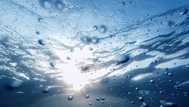 Air bubbles moving from the sea bottom to the water surface, with the soothing effect of sunlight. Ideal for an abstract backdrop