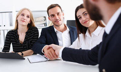 Smiling man in suit shake hands as hello in office portrait. Friend welcome mediation offer positive introduction greet or thanks gesture summit participate approval strike arm bargain concept