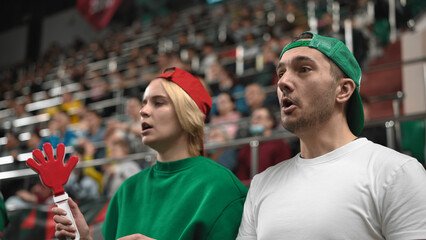 Football fans watch game match. Couple support favorite team. Crowd sport tribune. Soccer stadium...