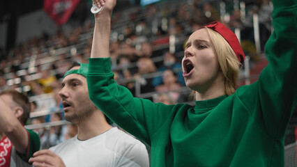 Football sport stadium. Man claps at soccer arena event. Guy fan cheer tribune. People win team cup. Crowd applaud score goal. Couple support favorite game play. Spectator watch match stands close up.