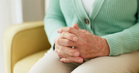 Hands, anxiety and senior woman on a sofa with stress, fear or grief, dementia or scared in her...