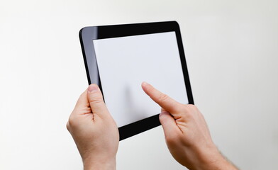 Man hoding black tablet frame in hand isolated on white closeup. Can insert an image image your text for the concept or project development of mobile applications, their advertising for mobile devices © H_Ko