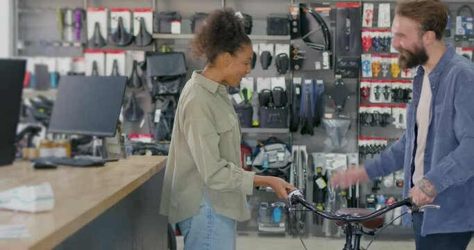 Female Customer Purchasing Bicycle in Store with Small Business Owner