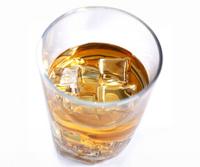 Whiskey with ice in a glass isolated on a white background