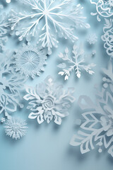Winter background with snowflakes in paper cut style. Light blue background