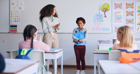 Class paper, presentation and child speaker with applause and cheering in classroom at school. Young kid, education and oral reading of project with student and teacher with children group discussion