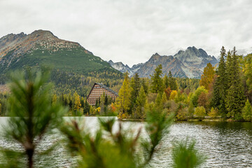 Beautiful autumn in the mountains of the High Tatras. Strbske Pleso lake with colorful mountains in background.