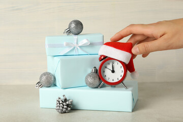 A clock with a Santa hat with a New Year's decoration.