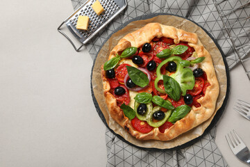 Freshly baked vegetable galette on the table with cutlery