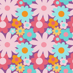 Floral vintage seamless pattern in pink, blue, yellow colors. Hippie flower power retro textile print. Groovy botanical wallpaper.