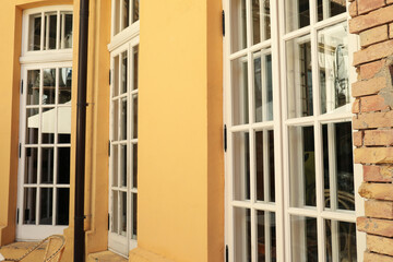 Yellow wall and windows on the facade of cafe, outdoors