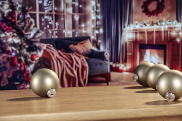 Desk of free space and christmas balls decoration. Home interior with fireplace and christmas tree. 