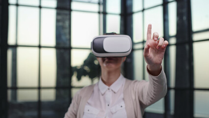 Office employee having fun at work, watching 3D video in virtual reality glasses