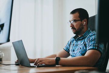 Portrait professional man programmer working concentrated on computer in diverse offices. Modern IT...