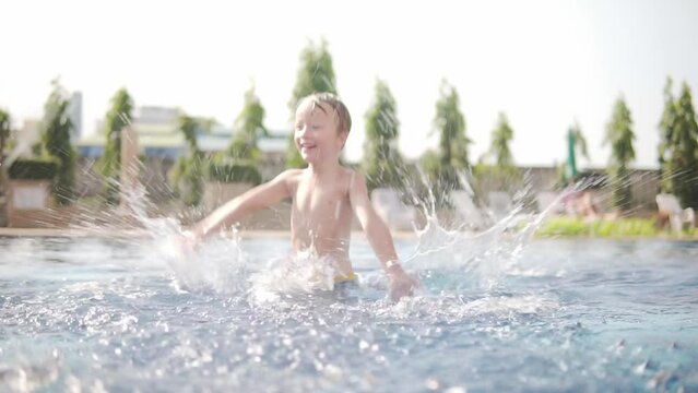 Little boy is frolicking in swimming pool