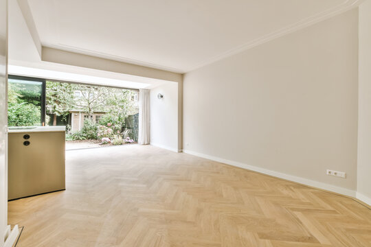 Empty room with white walls and large window