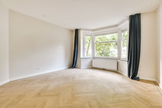 Empty room with bay window and radiator
