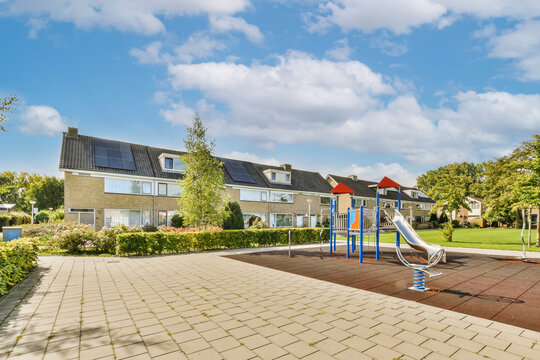 Buildings and playground against cloudy sky