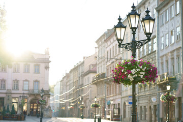 Lviv, Ukraine - 2021. May. View of the city streets of Lviv. Old town with historical buildings in the early morning at sunrise. There are many flowering plants on the city streets.