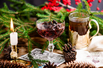 Jam from young pine cones in syrup on a background with pine branches