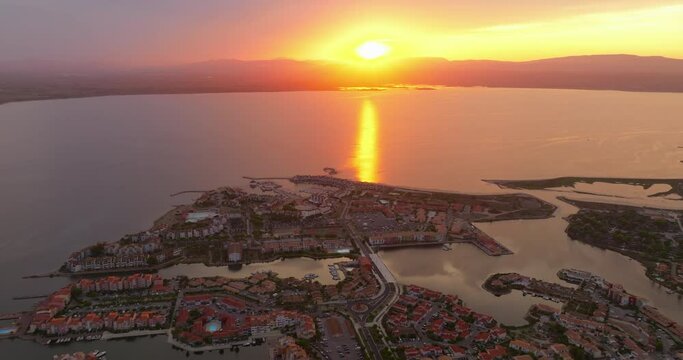 Drone view of the Leucate tourist spot on the Mediterranean Sea, southern France, in summer, during the height of the tourist season. Drone flies at a beautiful sunset