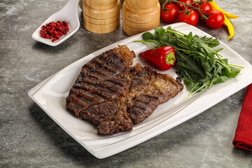 Grilled chuck roll steak with arugula