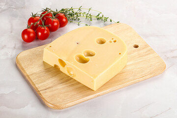 Maasdam cheese brick over board