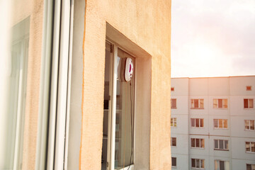 A modern vacuum robot window washer washes glass in an apartment on a balcony. View outside from...