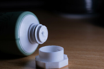A small green cream tube with the cap left empty. Cream that people like to use for health care
