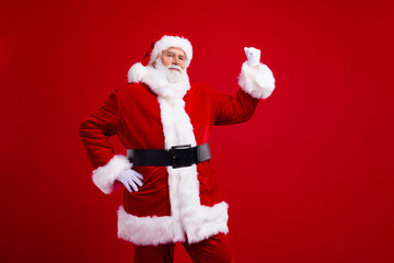 Photo of senior fat man saint nicholas rejoice celebrate low price proposition seasonal sale empty space isolated on red color background