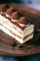 Italian dessert tiramisu close-up. Low key,