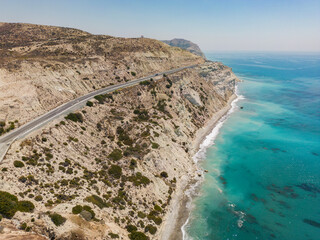 Panoramic view of rocky coast with turquoise water and clear blue sky in Paphos, Cyprus.