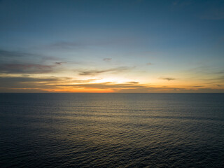 Naklejka premium Aerial view sunset sky over sea,Nature Light Sunset or sunrise over ocean,Colorful dramatic scenery sky, Amazing clouds and waves in evening sky, Beautiful light nature background