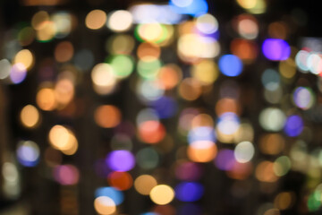 Festive multicolored city holiday lights blurred defocused bokeh balls of city downtown through fisheye lens 