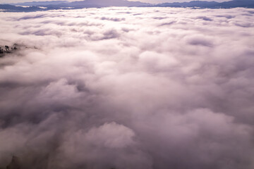 Amazing Sunrise or sunset over mountains hills covered with mist, Aerial view landscape drone shot beautiful colorful nature background