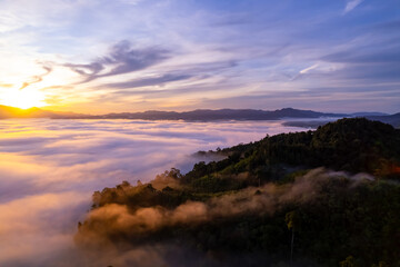 Amazing Sunrise or sunset over mountains hills covered with mist, Aerial view landscape drone shot beautiful colorful nature background