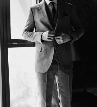 without a face. A man in a light-colored three-piece suit.