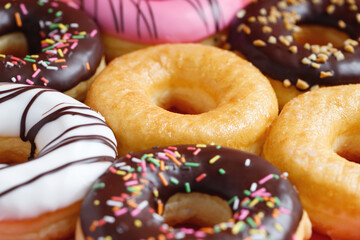 assorted donuts with chocolate frosting, topping sprinkles donuts Colorful variety and Variety of...
