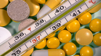 treatment at high temperatures. thermometer and pills