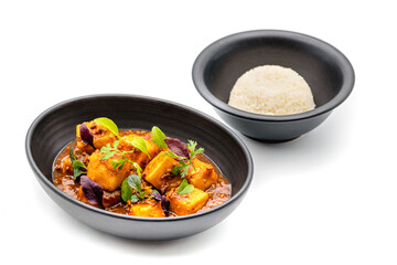 Mapo Tofu bowl with side sauces on white background
