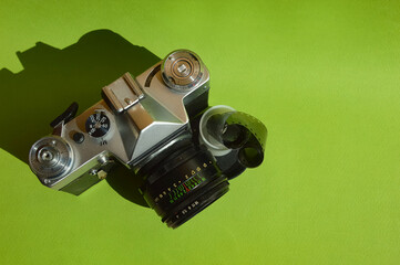 an old film camera, a lens. antique equipment. background for the design
