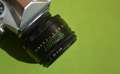 an old film camera, a lens. antique equipment. background for the design