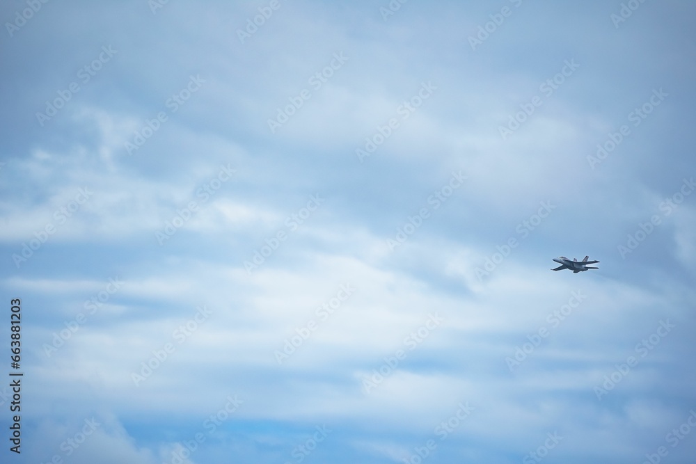 Wall mural Commercial airliner flying in a bright blue sky during the day