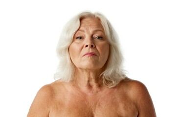 Portrait of beautiful senior woman in her 60s with blonde hair standing with bare shoulders against white background. Concept of natural beauty, aging process, elderly beauty, cosmetology, skincare