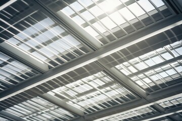 A picture of the ceiling of a building with numerous windows. This image can be used to illustrate architectural design, natural light, or modern construction